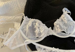 White Kelly lace bra laid flat on towels