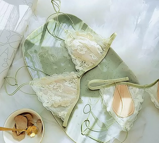 Flat lay image of two Dragonfly bras one showing the outside and one showing the inside of the cup